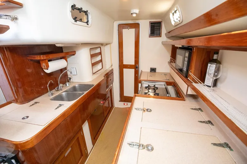 Slide: The Image of Flat-screen TV mounted on wooden interior of 1994 Morgan Catalina 38 yacht. - 34