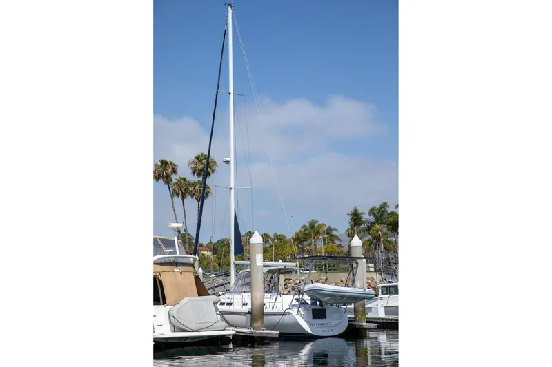 Slide: The Image of Sailboat Morgan Catalina 38, 1994 model, docked at marina with palm trees in background. - 4