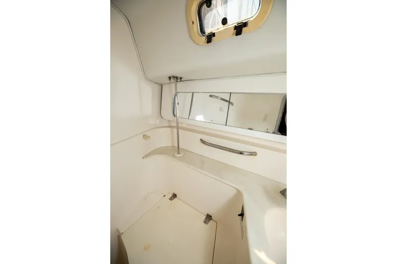 Slide: The Image of Interior of 1994 Morgan Catalina 38 sailboat bathroom with mirror and porthole. - 40