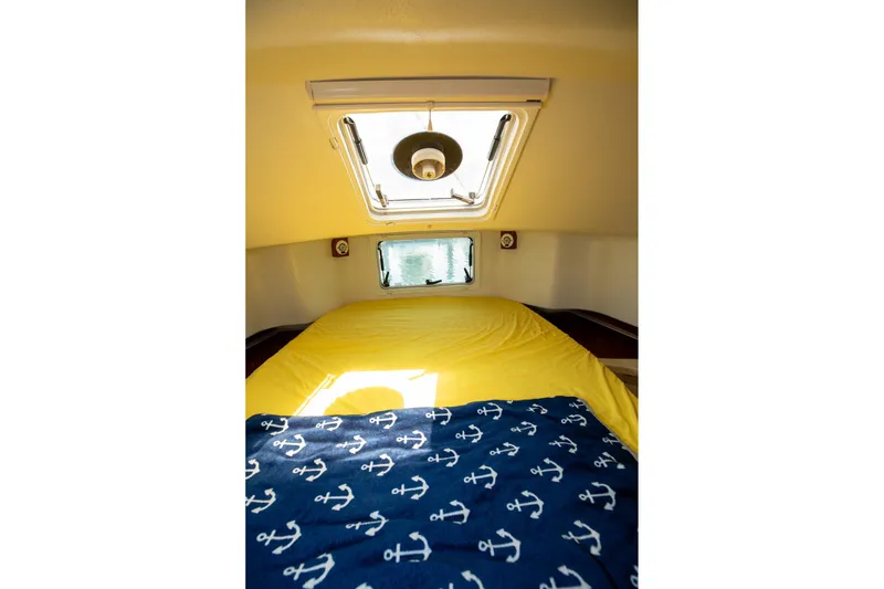 Slide: The Image of Cozy cabin interior of 1994 Morgan Catalina 38 sailboat with yellow bedding and nautical decor. - 45