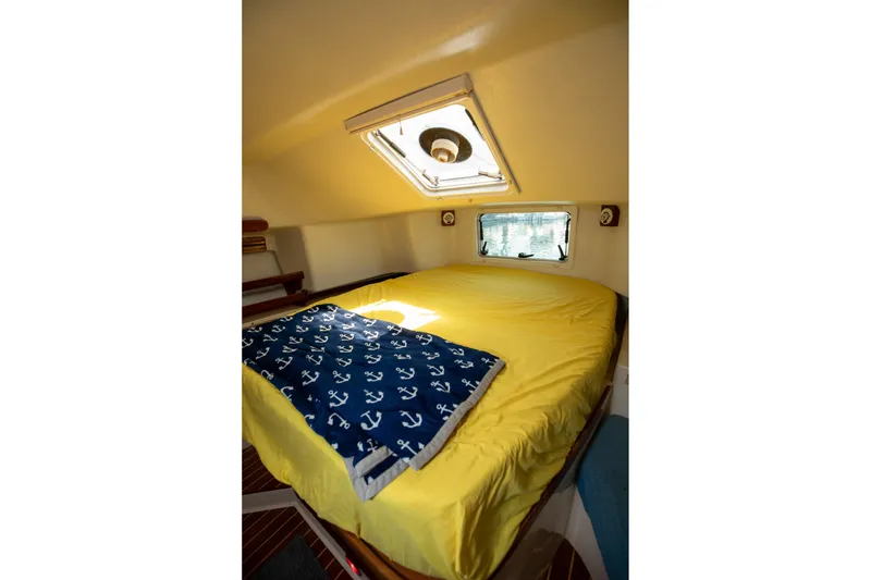 Slide: The Image of Cozy cabin interior of 1994 Morgan Catalina 38 with yellow bedding and window view. - 46