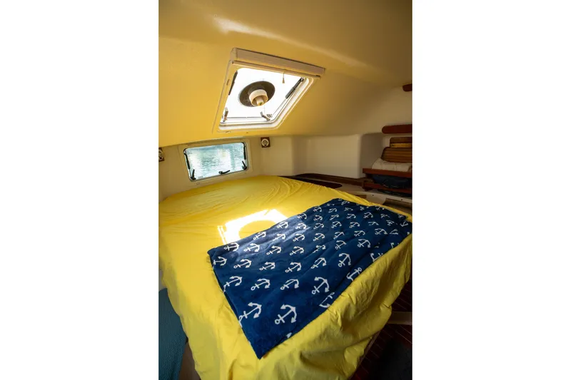 Slide: The Image of Cozy cabin interior of 1994 Morgan Catalina 38 sailboat with yellow bedding and nautical decor. - 47