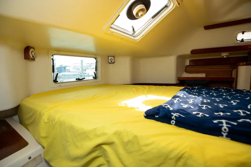 Slide: The Image of Cozy cabin interior of 1994 Morgan Catalina 38 sailboat with nautical-themed bedding. - 48