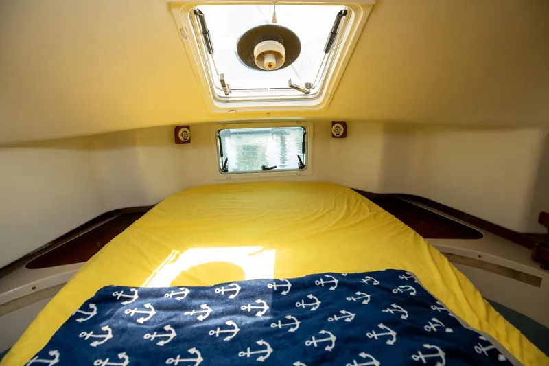 Slide: The Image of Cozy cabin interior of 1994 Morgan Catalina 38 sailboat with yellow bedding and nautical decor. - 50