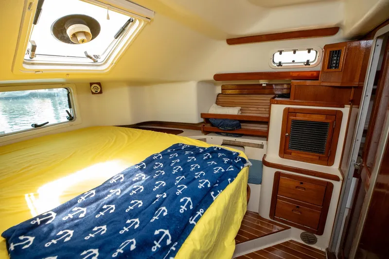 Slide: The Image of Interior of 1994 Morgan Catalina 38 yacht bathroom with storage shelves and porthole. - 51