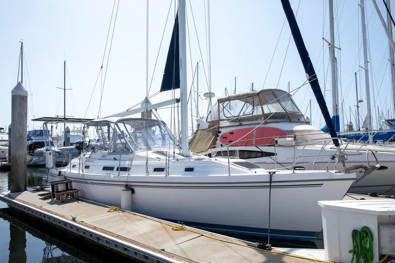 Slide: The Image of 1994 Morgan Catalina 38 sailboat docked at marina, surrounded by other boats. - 7