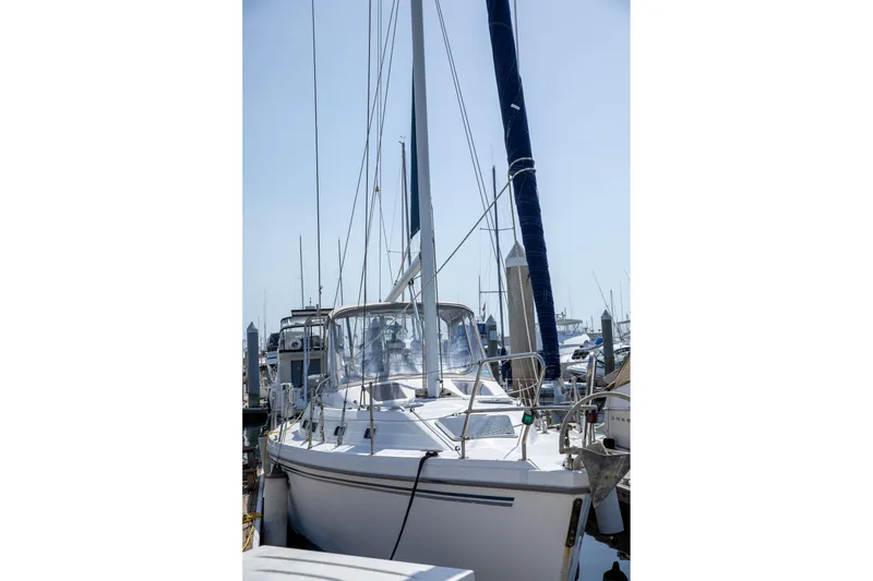 Slide: The Image of Sailboat Morgan Catalina 38, 1994 model, docked at marina under clear sky. - 8
