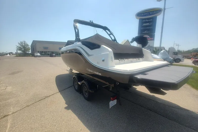 The Image of 2023 Bayliner DX 2250 boat on trailer at dealership parking lot. - 0