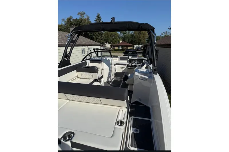 Slide: The Image of 2023 Bayliner DX 2250 boat interior with sleek seating and modern dashboard. - 11