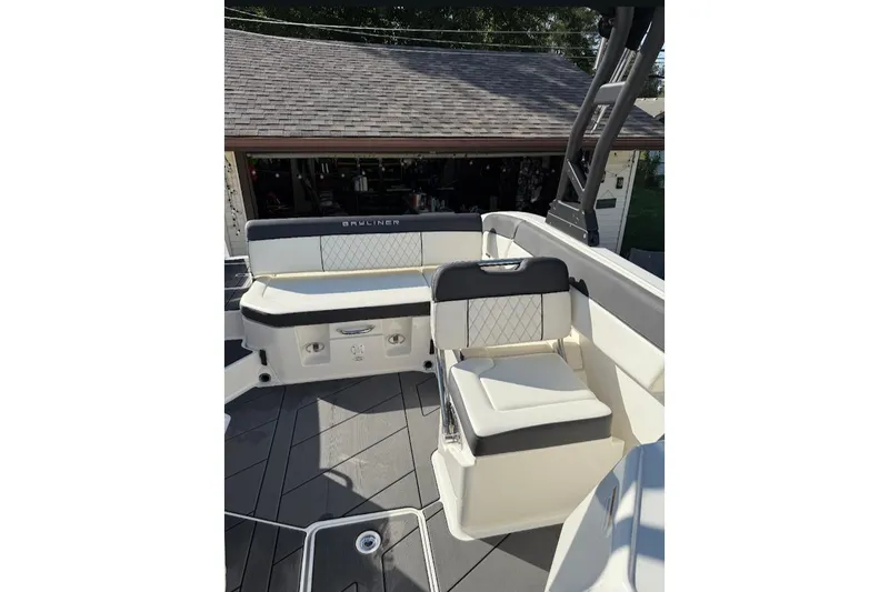 Slide: The Image of 2023 Bayliner DX 2250 boat interior with cushioned seating and sleek design. - 13
