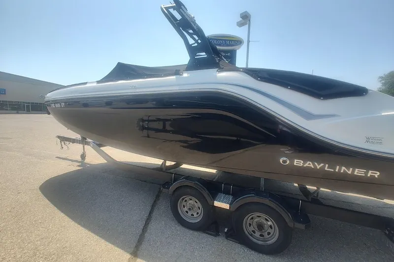 Slide: The Image of 2023 Bayliner DX 2250 boat on trailer in outdoor setting. - 2
