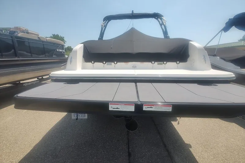 Slide: The Image of 2023 Bayliner DX 2250 boat rear view with swim platform and cover. - 5