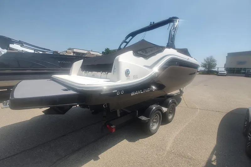 Slide: The Image of 2023 Bayliner DX 2250 boat on trailer in sunny outdoor setting. - 7