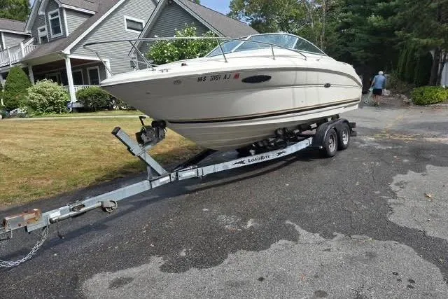 Slide: The Image of 2004 Sea Ray 215 Weekender boat on trailer in residential driveway. - 3