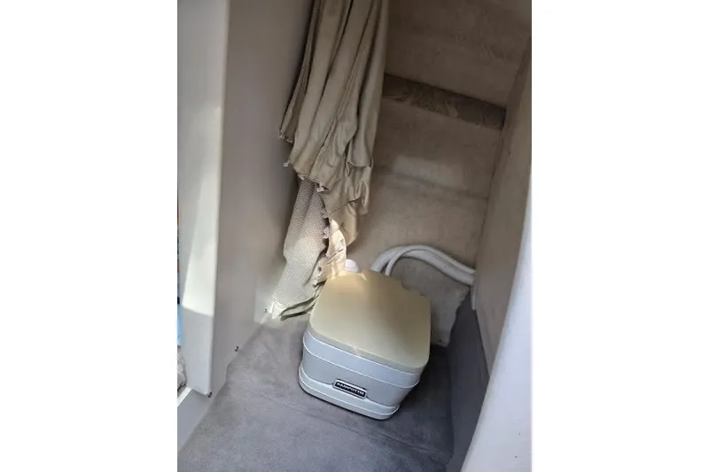 Slide: The Image of Interior of 2004 Sea Ray 215 Weekender with portable toilet and curtain. - 5