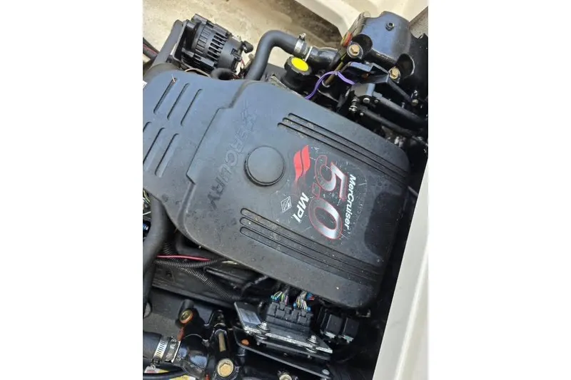 Slide: The Image of Engine of a 2004 Sea Ray 215 Weekender boat, featuring a MerCruiser 5.0 MPI. - 7