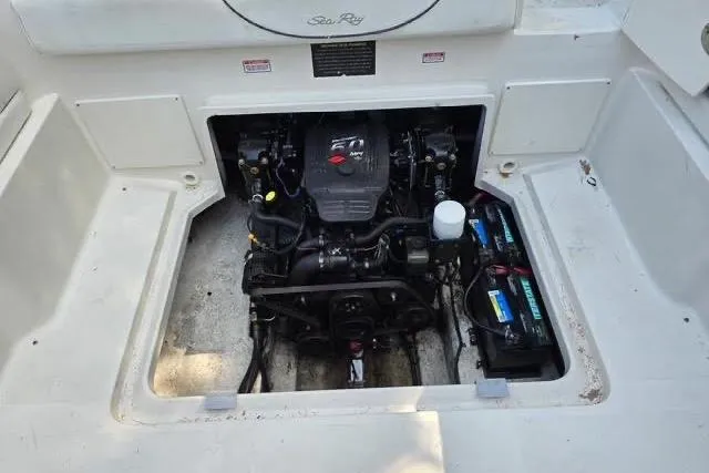Slide: The Image of Engine compartment of a 2004 Sea Ray 215 Weekender boat, showcasing the engine and battery. - 8