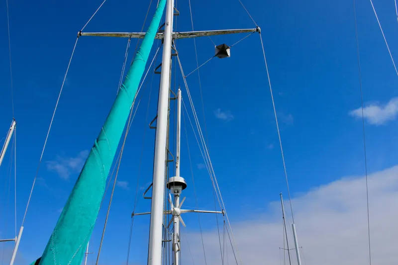 Slide: The Image of Mast of 1975 Downeast 38 sailboat against clear blue sky. - 10