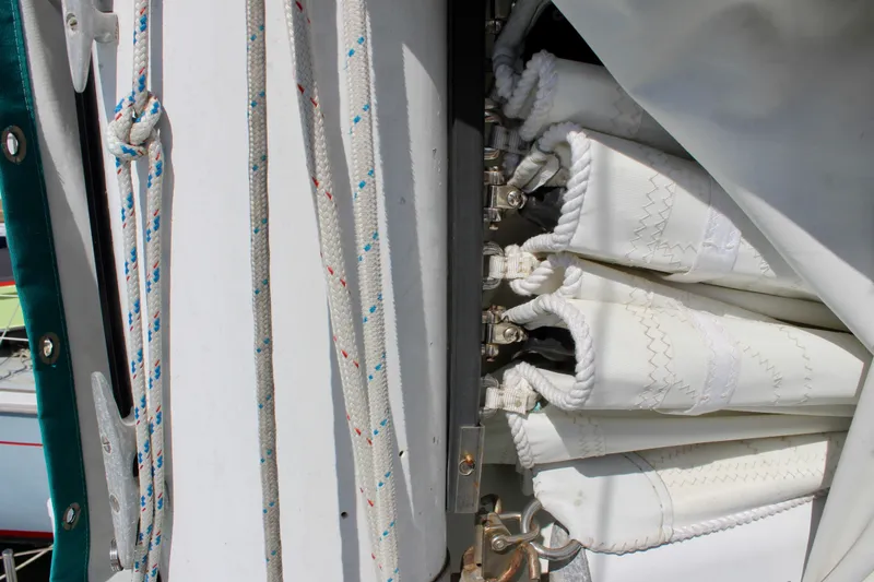Slide: The Image of Close-up of sail rigging on a 1975 Downeast 38 boat, featuring ropes and sail details. - 12