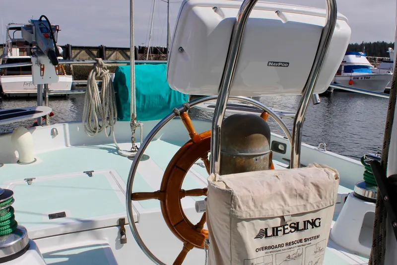 Slide: The Image of 1975 Downeast 38 sailboat cockpit with steering wheel and Lifesling rescue system. - 17