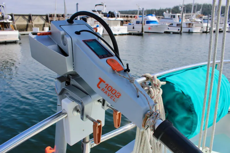 Slide: The Image of Electric outboard motor on a 1975 Downeast 38 sailboat, docked at a marina. - 19