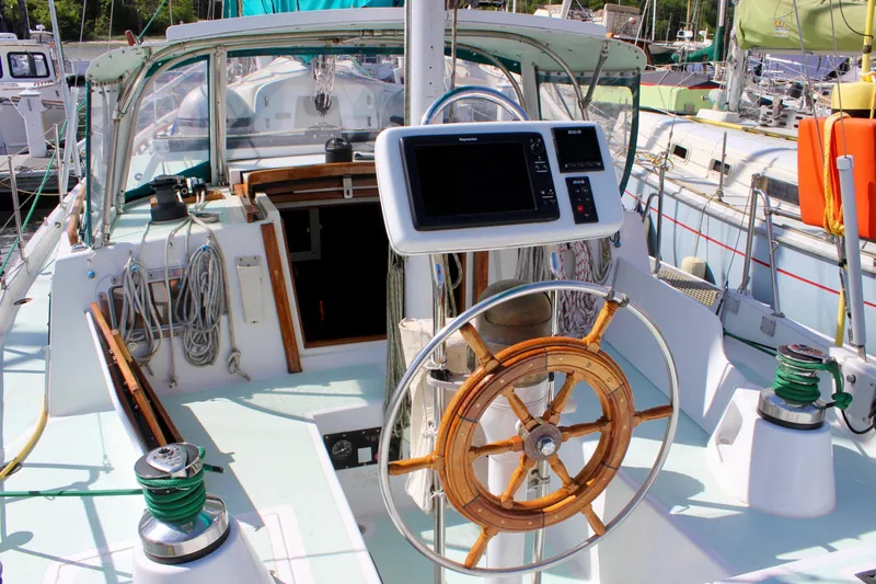 Slide: The Image of Cockpit of a 1975 Downeast 38 sailboat with steering wheel and navigation equipment. - 21