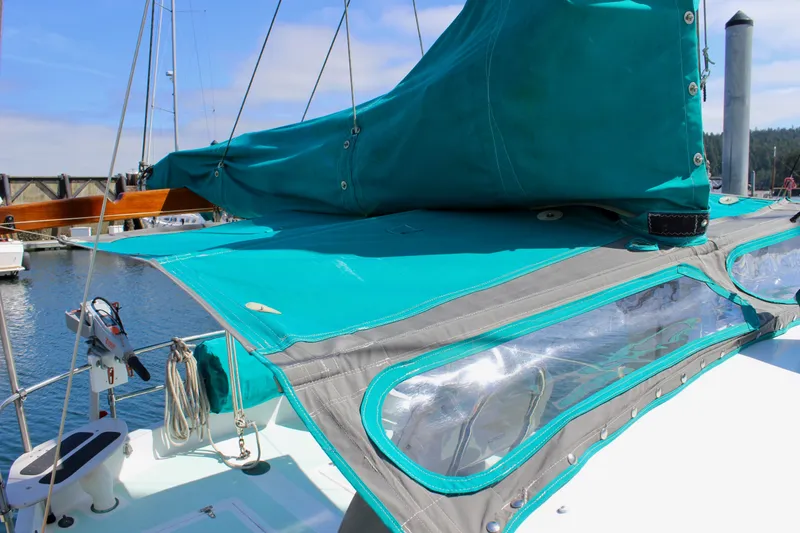 Slide: The Image of 1975 Downeast 38 sailboat with turquoise canvas cover docked at marina. - 29