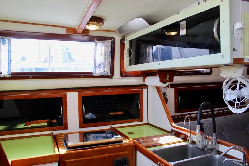 Slide: The Image of Interior of a 1975 Downeast 38 sailboat featuring a compact kitchen area. - 32