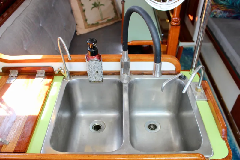 Slide: The Image of Double sink in a 1975 Downeast 38 boat galley with soap dispenser. - 34