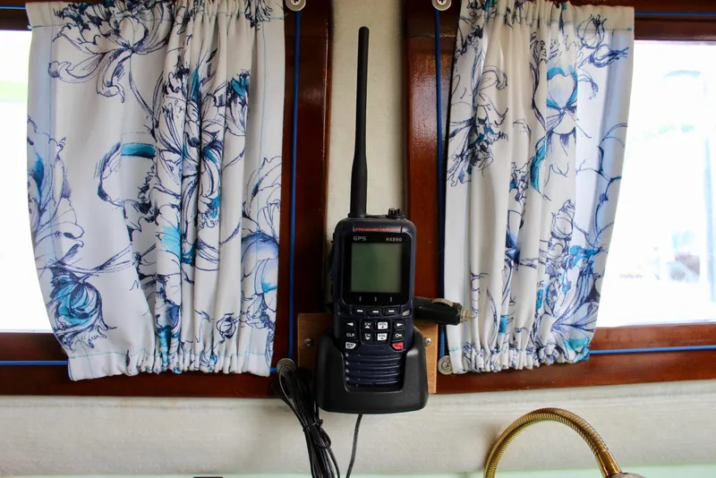Slide: The Image of Vintage Downeast 38 boat interior with floral curtains and mounted radio equipment. - 40