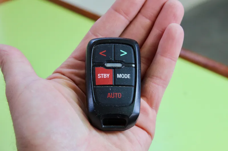 Slide: The Image of Hand holding a remote control with buttons labeled STBY, MODE, AUTO. - 43