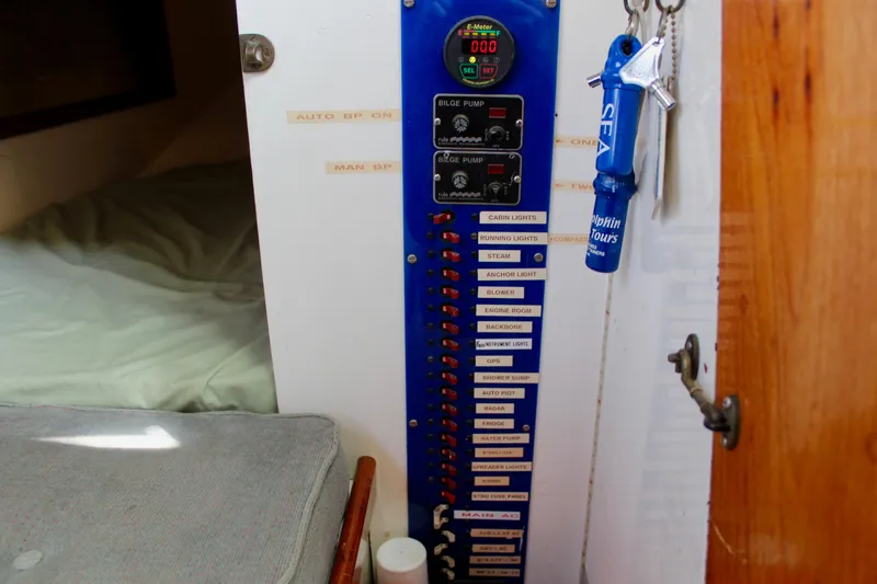 Slide: The Image of Electrical panel inside a 1975 Downeast 38 boat, featuring labeled switches and keys. - 44