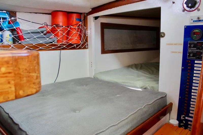 Slide: The Image of Interior of a 1975 Downeast 38 sailboat with storage and sleeping area. - 45