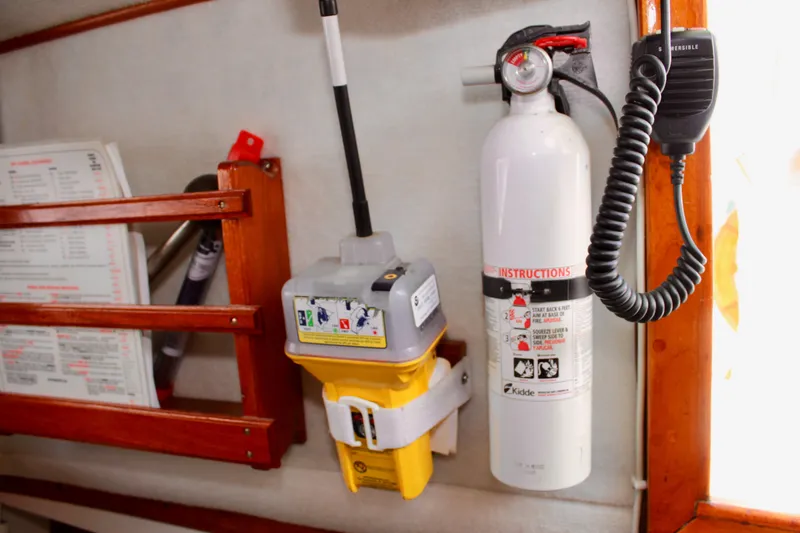 Slide: The Image of Safety equipment on a 1975 Downeast 38 boat, featuring a fire extinguisher and emergency beacon. - 47