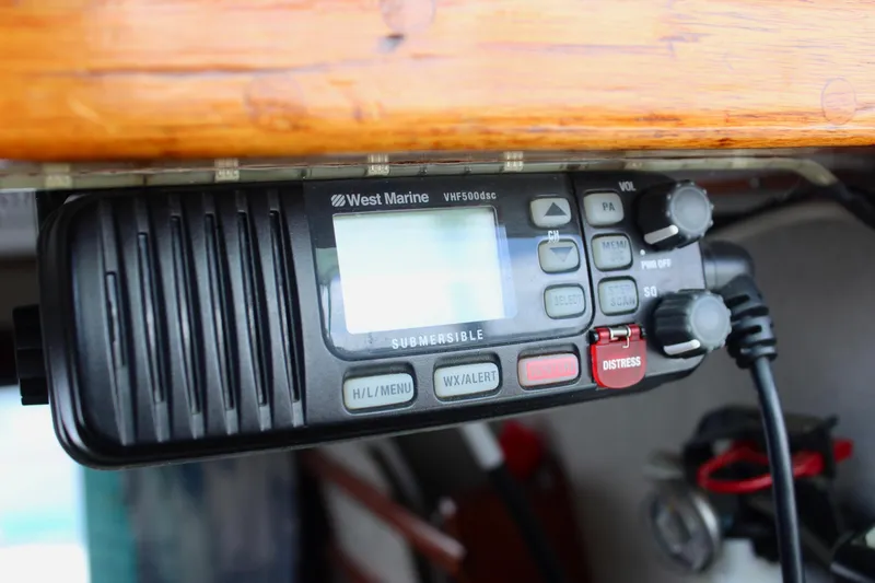 Slide: The Image of West Marine VHF500dsc radio on 1975 Downeast 38 boat, featuring distress button. - 48