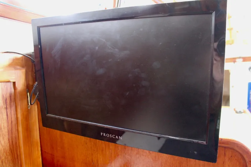 Slide: The Image of Proscan TV mounted on a wooden interior of a 1975 Downeast 38 boat. - 53