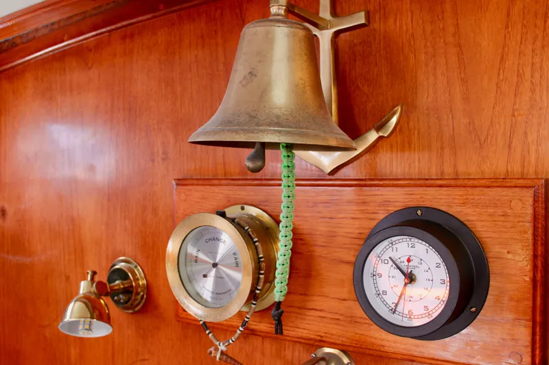 Slide: The Image of Vintage nautical instruments and bell on 1975 Downeast 38 wooden interior. - 54