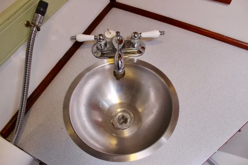 Slide: The Image of Stainless steel sink with dual-handle faucet on 1975 Downeast 38 boat. - 59