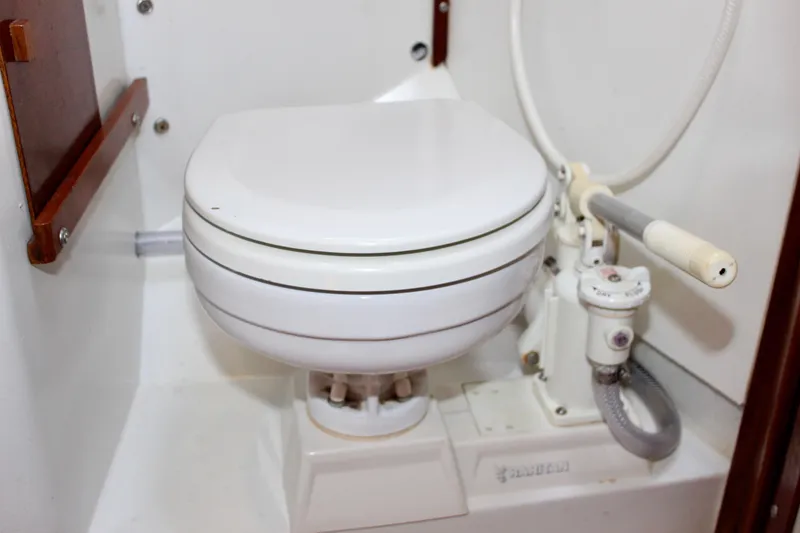 Slide: The Image of Marine toilet in a 1975 Downeast 38 boat, featuring manual pump system. - 60