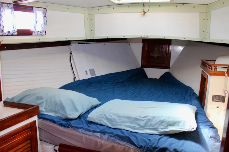 Slide: The Image of Cozy cabin interior of a 1975 Downeast 38 sailboat with a comfortable bed setup. - 64