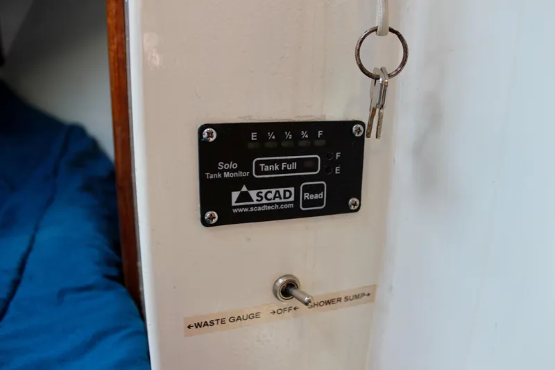 Slide: The Image of Tank monitor on 1975 Downeast 38 boat, showing full tank and waste gauge switch. - 69
