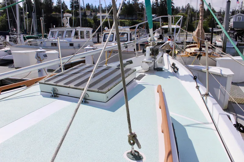 Slide: The Image of Deck view of a 1975 Downeast 38 sailboat docked at a marina. - 7