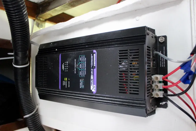 Slide: The Image of Battery charger installed in a 1975 Downeast 38 boat, featuring wiring and ventilation. - 74