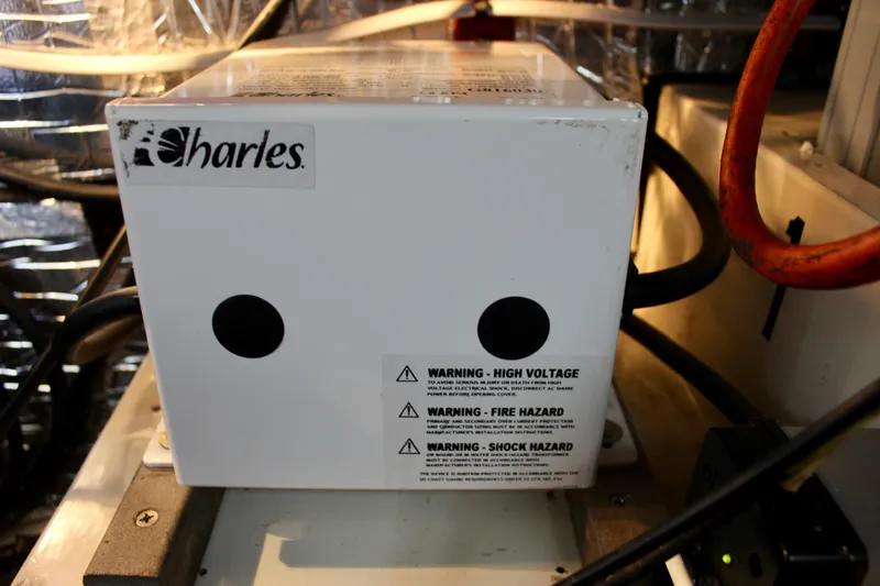 Slide: The Image of Electrical component with warning labels inside a 1975 Downeast 38 boat. - 75