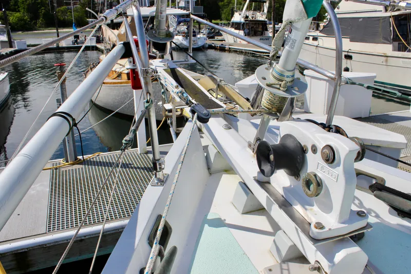 Slide: The Image of Deck view of a 1975 Downeast 38 sailboat, showcasing rigging and winch details at the marina. - 8