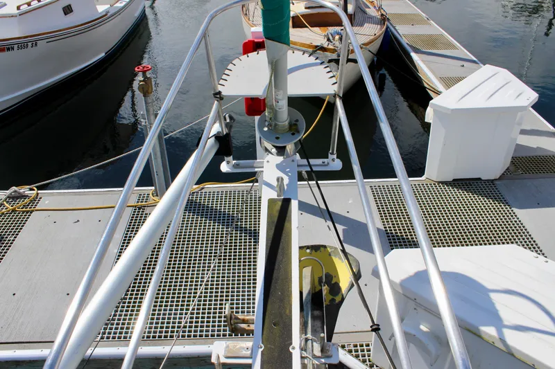 Slide: The Image of Bow of a 1975 Downeast 38 sailboat docked at a marina. - 9