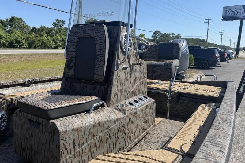 Slide: The Image of 2026 Xpress H22B Bay boat with camouflage design, featuring seating and console. - 10