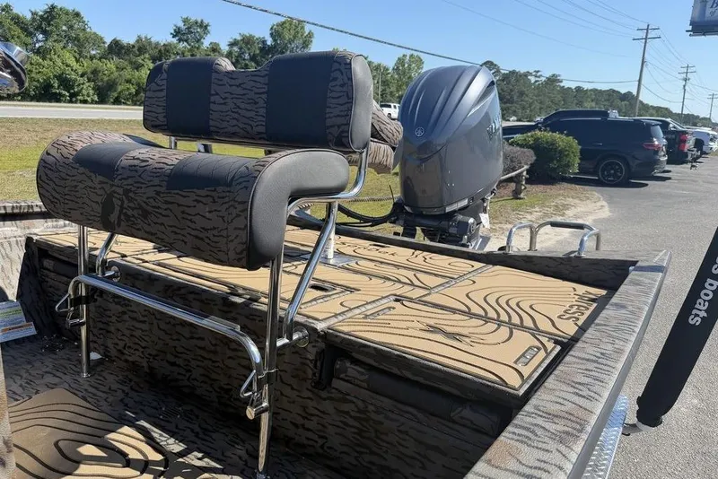 Slide: The Image of 2026 Xpress H22B Bay boat with patterned seating and powerful outboard motor. - 3
