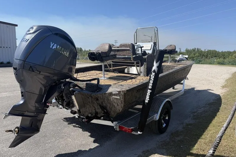 Slide: The Image of 2026 Xpress H22B Bay boat with Yamaha engine on trailer, parked outdoors. - 6