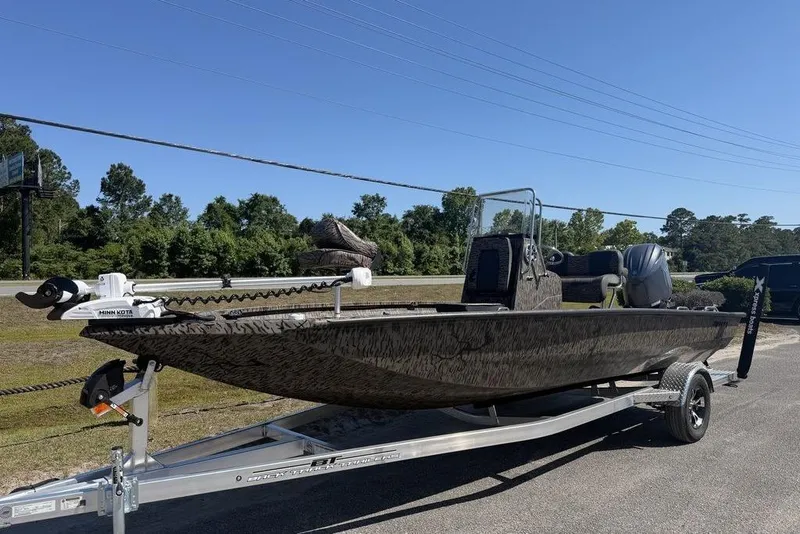 The Image of 2026 Xpress H22B Bay boat on trailer, featuring Minn Kota trolling motor. - 1